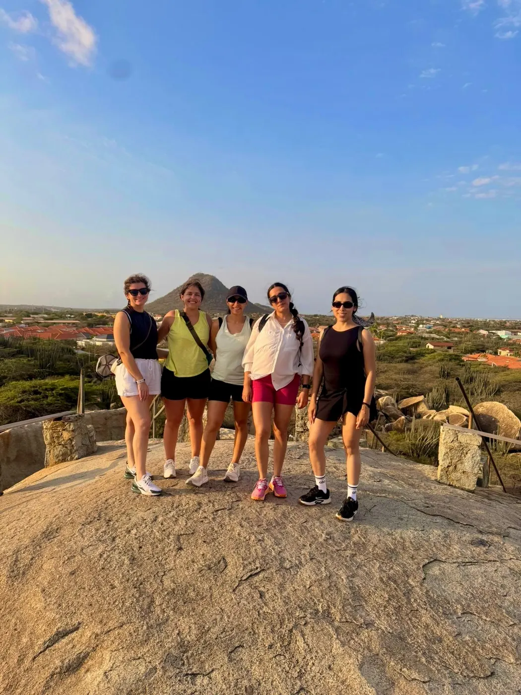 Group of friends hiking at sunset near Hooiberg